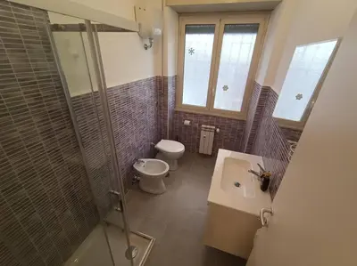 a bathroom with a toilet and a shower and a sink at CasaLara Garden in Rome