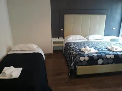 a hotel room with two beds with towels on them at Modern BnB in Rome