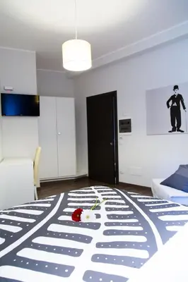 a room with a bed with a flower on it at Modern BnB in Rome