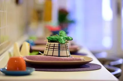 a toy frog sitting on a plate on a table at Madì B&B in Rome
