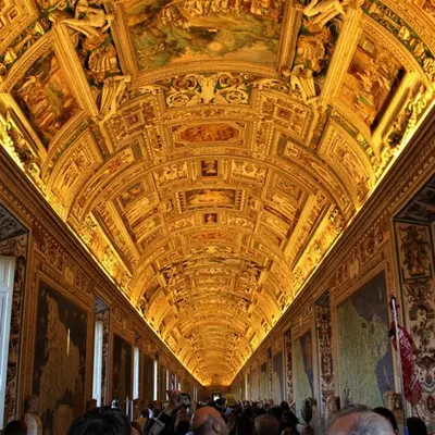 a crowd of people in a large room with a ceiling at “Suite Home Vaticano City” in Rome