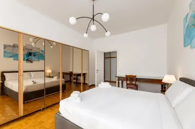 a large bedroom with two beds and a desk at Presidential Vatican Palace in Rome