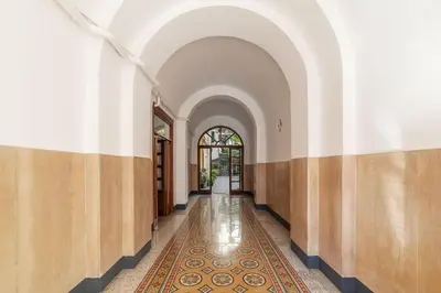 an arcade with a hallway with a rug on the floor at GuestHost - Vittorio Emanuele Elegant Apartment in Rome