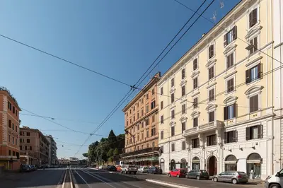 a street with buildings and cars parked on the street at GuestHost - Vittorio Emanuele Elegant Apartment in Rome