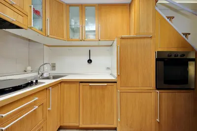 a kitchen with wooden cabinets and a black microwave at Vatican d'Elite in Rome