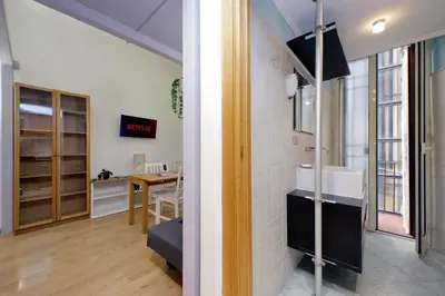 a bathroom with a sink and a table in a room at Vatican d'Elite in Rome