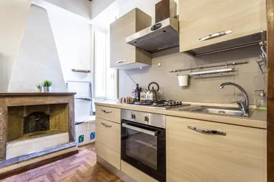 a kitchen with a stove top oven next to a fireplace at sacra mysteria vatican in Rome