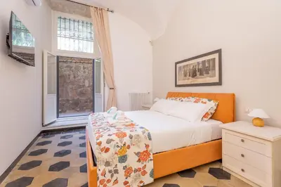 a bedroom with a bed and a window at Prati 3BDR Urban Charm in Rome