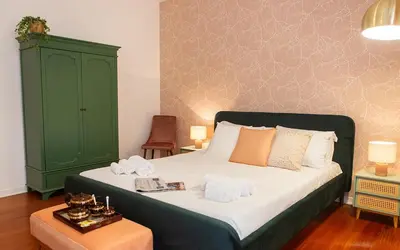 a bedroom with a large bed with a green cabinet at Termini Alever apartament 3 bedrooms in Rome
