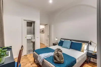 a bedroom with a bed with a backpack on it at Margana Apartment - Maison D'art Collection in Rome