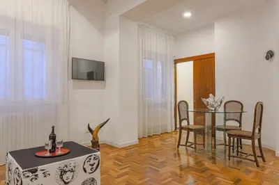 a dining room with a table and chairs and a television at Piazza Navona Deluxe Apartment - Piano 2 Roma in Rome