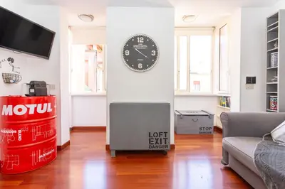 a living room with a clock on a wall at Casa Miso in Rome