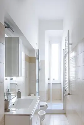a white bathroom with a sink and a toilet at EasySleep Vaticano in Rome