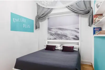 a bed in a room with a window and a sign at Suite Design Piazza di Spagna in Rome
