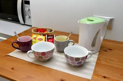 three coffee cups sitting on a kitchen counter at Diamond Apartments in Rome