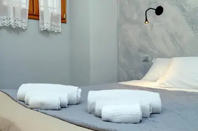 a bedroom with two beds with white towels on them at Diamond Apartments in Rome