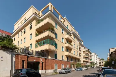 a tall building with cars parked in front of it at GuestHost - Piazza Bologna Sweet Apartment in Rome