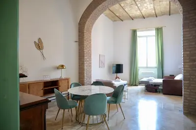 a living room with a table and chairs at Fororomano Luxury in Rome