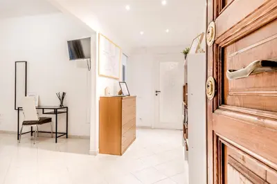 a living room with a wooden door and a desk at Petite Maison 19 in Rome