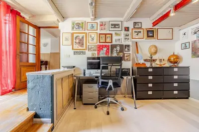 an office with a desk and a computer on a wall at Riad Riari in Rome