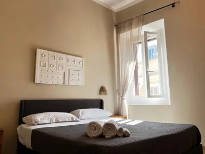 a bedroom with a bed with two towels on it at Trastevere Suite apartment in Rome