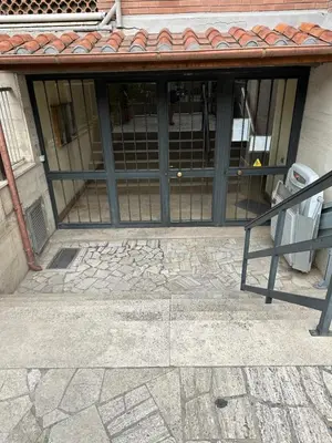 a building with a glass door with a fence at Santo Apartment in Trastevere in Rome