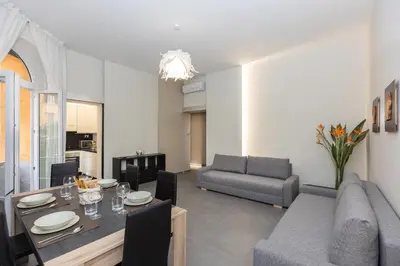 a living room with a couch and a dining room at San Pietro Guest House in Rome