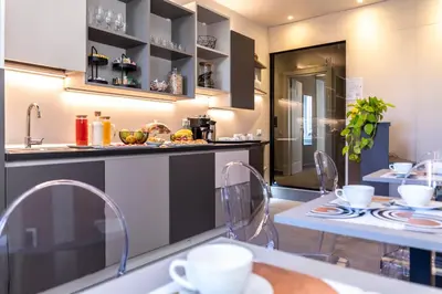 a kitchen with two tables and a counter top at Trastevere 143 in Rome