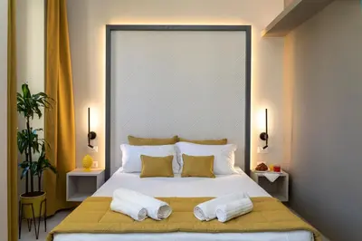 a bedroom with a large white bed with two pillows at Trastevere 143 in Rome