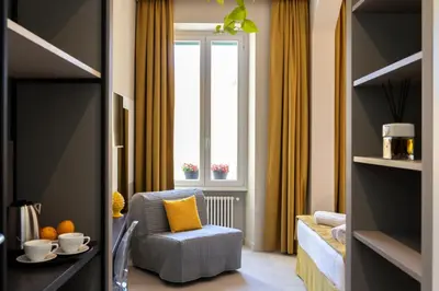 a living room with a chair and a window at Trastevere 143 in Rome