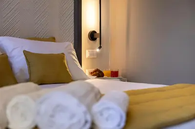 a bed with white sheets and pillows in a room at Trastevere 143 in Rome
