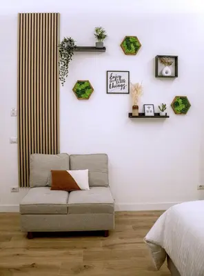 a living room with a couch against a white wall at SIRI VATICAN LOFT - Design House Rome in Rome