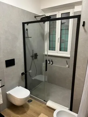 a bathroom with a shower with a toilet and a sink at SIRI VATICAN LOFT - Design House Rome in Rome
