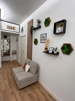 a living room with a couch on a white wall at SIRI VATICAN LOFT - Design House Rome in Rome