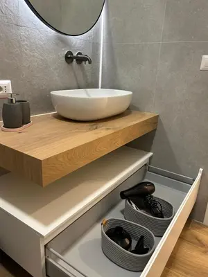 a bathroom with a counter with a sink and a mirror at SIRI VATICAN LOFT - Design House Rome in Rome