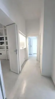 an empty white room with a door and a hallway at Piazza di Spagna Home - Family Apartment in Rome