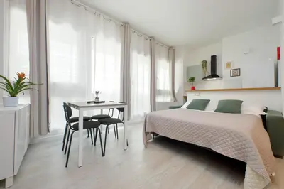 a bedroom with a bed and a desk and a table at Porta San Giovanni Suite in Rome