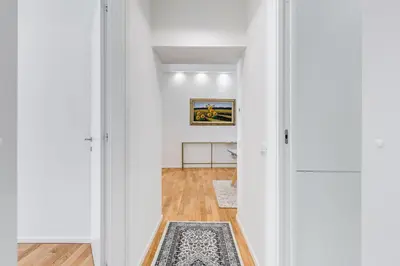 a hallway with white walls and wood floors at Opera Exclusive House by Premium Suites Collection in Rome