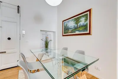 a glass table and chairs in a white room at Opera Exclusive House by Premium Suites Collection in Rome