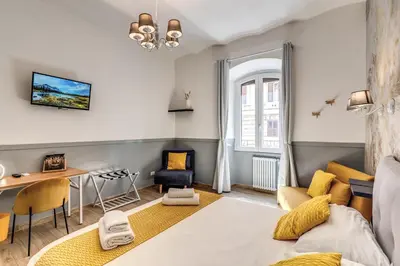 a living room with a blue couch and a table at Nala Luxury Apartment with terrace in Rome