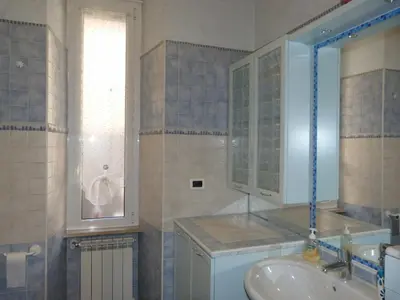a bathroom with a sink and a mirror and a tub at Rossanella House in Rome