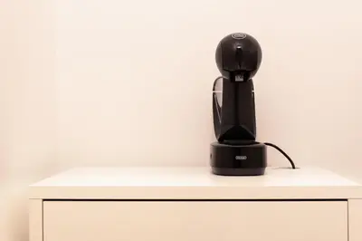 a black coffee maker sitting on top of a cabinet at Charme & Chic San Giacomo in Rome