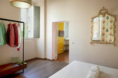 a bedroom with a bed and a mirror on the wall at TrastevereHome - Santa Maria della Quercia in Rome