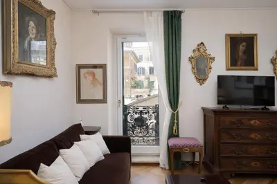 a living room with a couch and a tv and a window at On The Steps in Rome