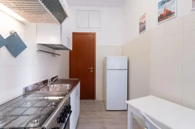 a small kitchen with a sink and a refrigerator at Casa Riboty in Rome