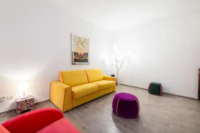 a living room with a yellow couch and a table at Casa Riboty in Rome