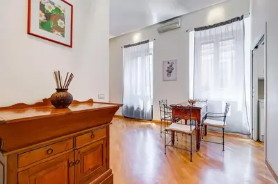 a kitchen with a table and chairs and a dining room at Crescenzio St Peter’s House in Rome
