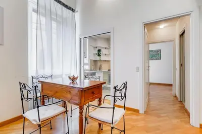 a dining room with a wooden table and chairs at Crescenzio St Peter’s House in Rome