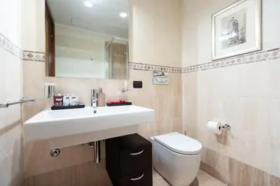 a bathroom with a white sink and a toilet at TimeRoma Vatican in Rome