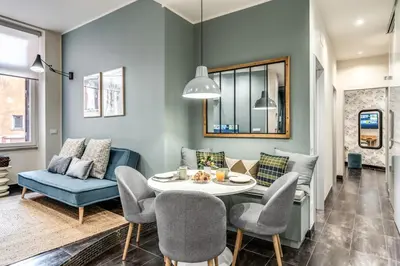 a living room with a table and chairs and a couch at Daag Corso Luxury Apartment in Rome